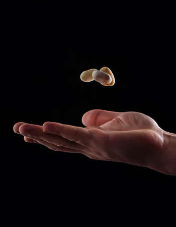 Hand with floating pebble stack finding inner peace concept gravityの写真素材