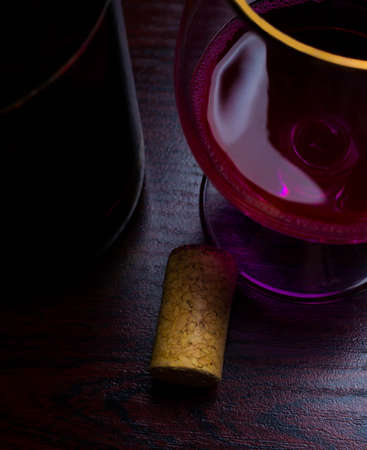 drop wine stopper bottle movement red background splash glassの写真素材