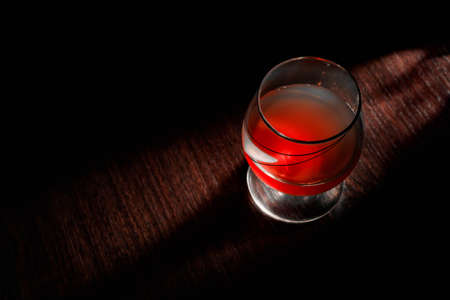 Glass of whiskey with smoking cigar and ice cubes on wooden table bar, wine, luxuryの写真素材