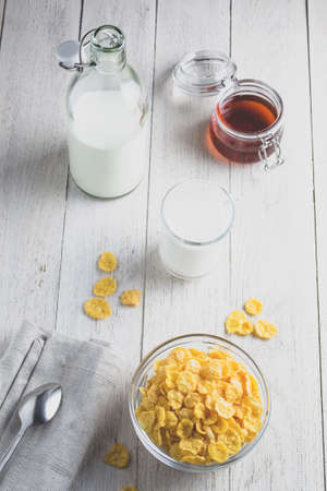 Cornflakes and milk on a light wooden backgroundの写真素材