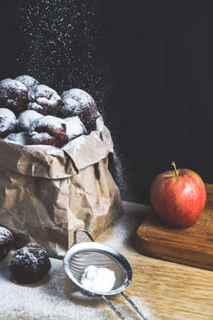 Homemade cakes in powdered sugar on black backgroundの写真素材