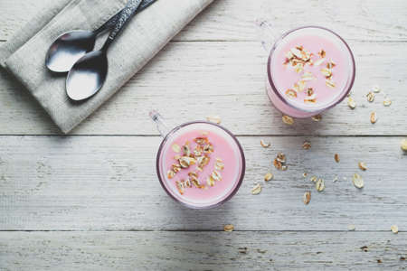 Yoghurt and muesli on a light wooden backgroundの写真素材