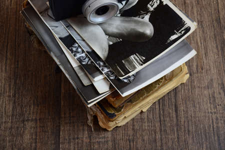 Old books, lens and black-and-white photographsの写真素材