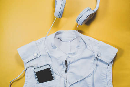 Gadgets and summer clothes on yellow backgroundの写真素材