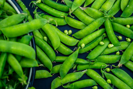 Green peas on black background