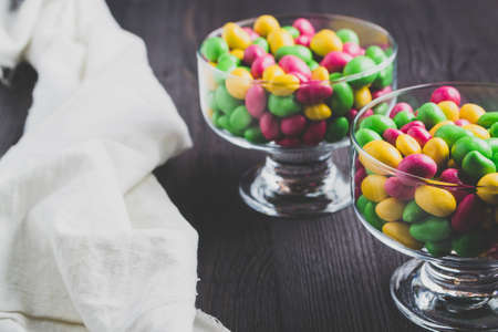 Colorful candies on a dark wooden background