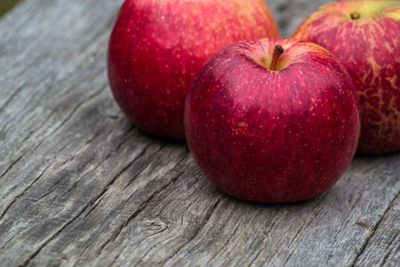Fresh red apples on a wooden table