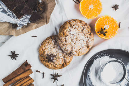 Biscuits, citrus and chocolate on a light backgroundの写真素材