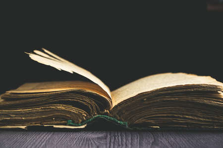 Old open book on dark backgroundの写真素材