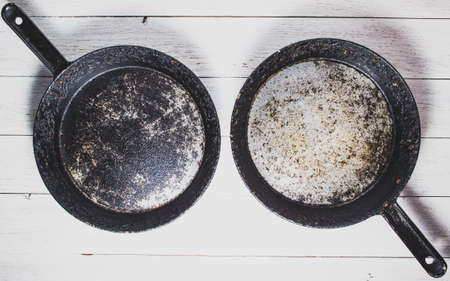 Two old pans on a light backgroundの写真素材