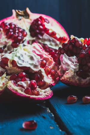 Red pomegranate on a dark blue backgroundの写真素材