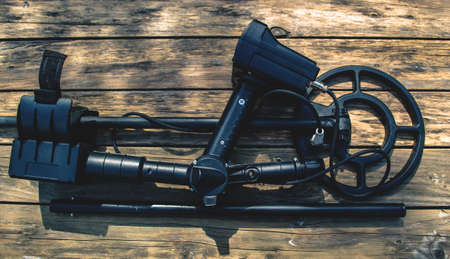Metal detector on wood backgroundの写真素材