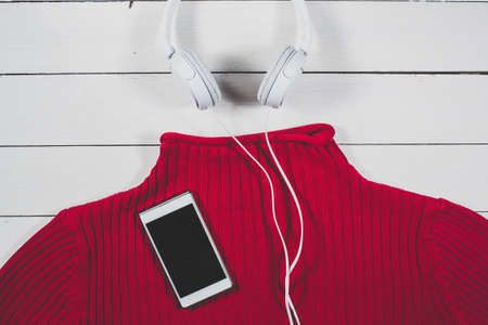 Gadgets and summer clothing on a bright wooden backgroundの写真素材