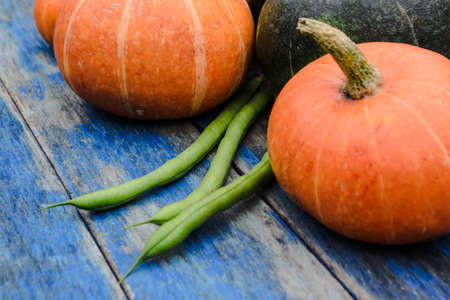 Orange pumpkins on the background of the old blue wooden tableの写真素材