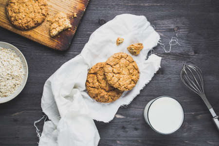 Cookies and milk on a dark wooden backgroundの写真素材