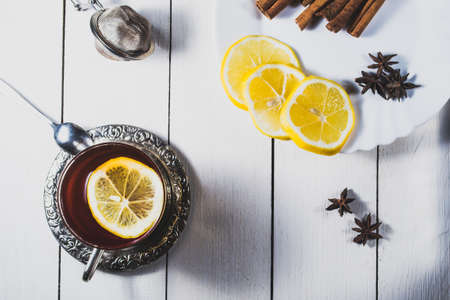 Tea with lemon and sweets on the tableの写真素材