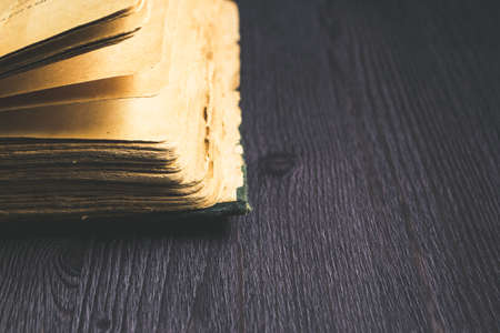 Old open book on dark backgroundの写真素材
