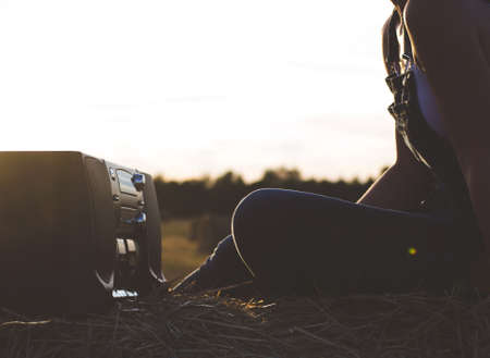 Woman holding an old cassette recorder