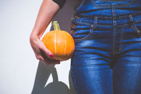 Woman farmer holding a pumpkinの写真素材