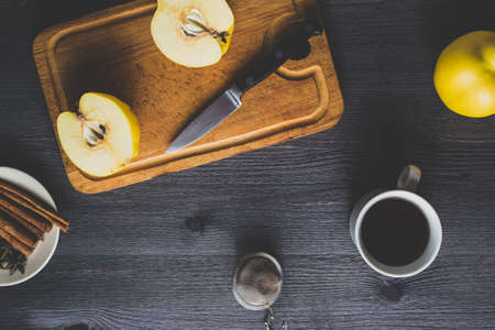 Yellow quince and tea on dark wooden backgroundの写真素材