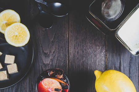 Mulled wine and ingredients on a dark wooden tableの写真素材