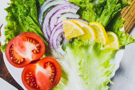 Vegetable salad on a light wooden tableの写真素材