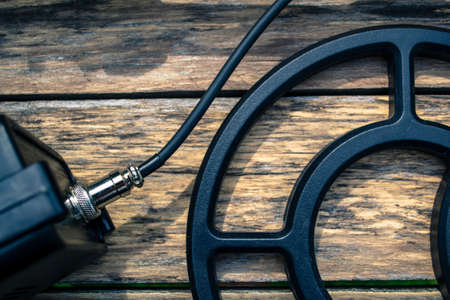 Metal detector on wood backgroundの写真素材