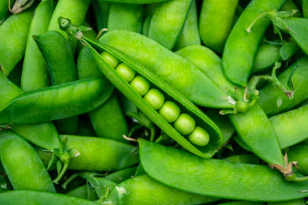 Green peas on a wooden tableの写真素材