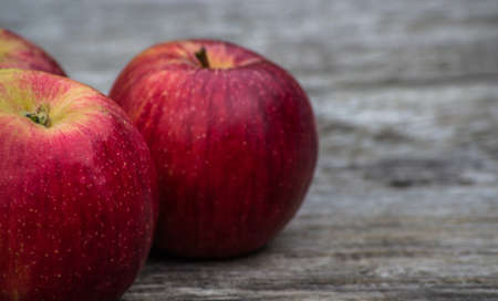 Fresh red apples on a wooden tableの写真素材