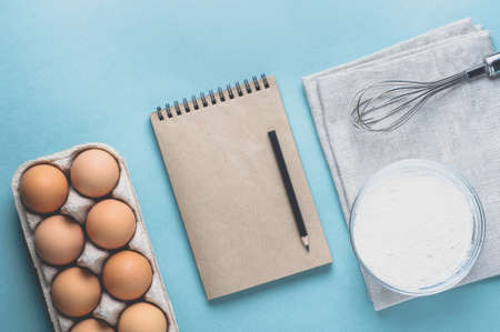 Eggs and ingredients for baking on a light green background. Top view and flat layの写真素材