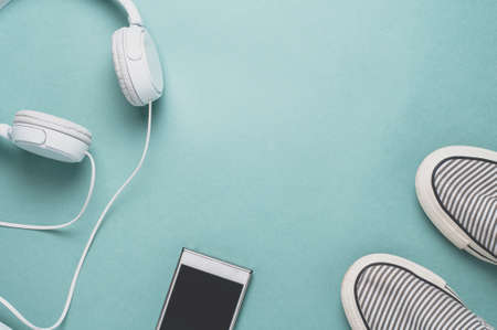 Shoes and gadgets on a bright green backgroundの写真素材