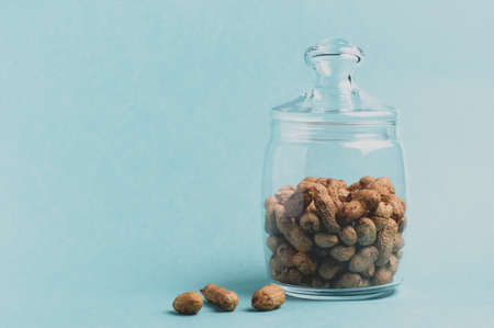 Peanuts in a jar on a green backgroundの写真素材