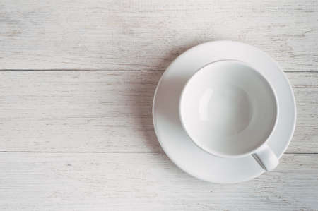 Empty white Cup on white wooden backgroundの写真素材