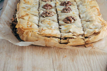 Fresh homemade baklava on a light wooden backgroundの写真素材