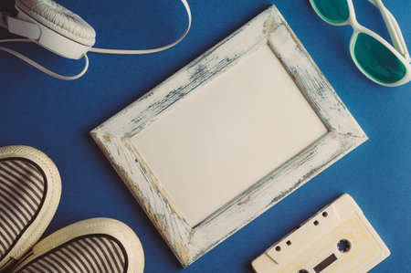 Audio cassette and headphones on a blue background. Mock upの写真素材