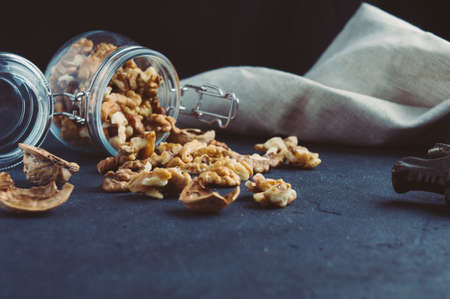 Walnuts in a jar on a dark backgroundの写真素材