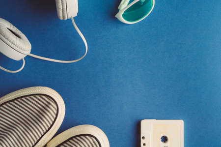 Audio cassette and headphones on a blue background. Music conceptの写真素材