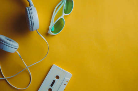 Audio cassette and headphones on a yellow background. Music conceptの写真素材