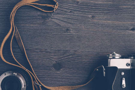 Old camera and lenses on dark wooden backgroundの写真素材