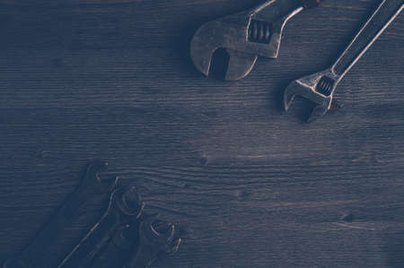 Old tools on a dark wooden background. Top viewの写真素材
