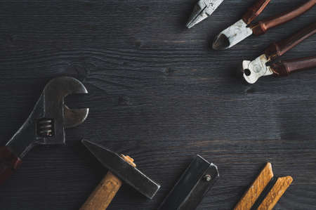 Old tools on a dark wooden background. Top viewの写真素材