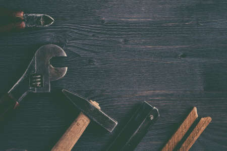 Old tools on a dark wooden background. Top viewの写真素材