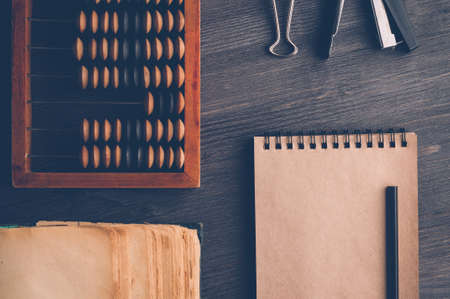 Old wooden abacus on dark background. The concept of bookkeeping, business or saving moneyの写真素材