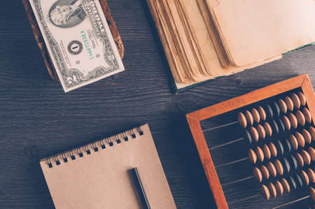 Old wooden abacus on dark background. The concept of bookkeeping, business or saving moneyの写真素材