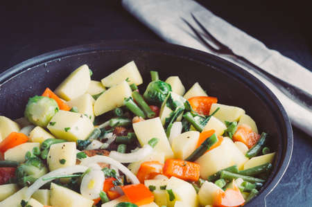 Vegetable mix in a frying pan on a dark backgroundの写真素材