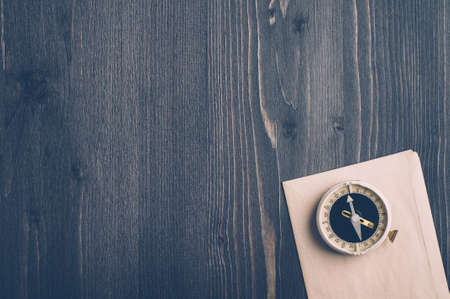 Old compass on a dark wooden backgroundの写真素材