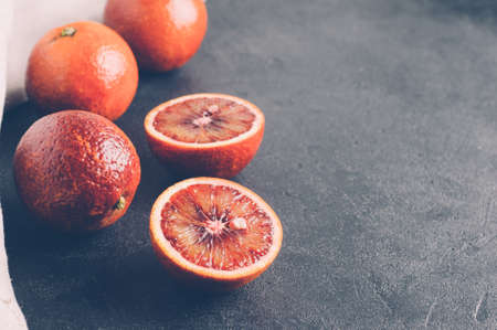 Red oranges on a dark stone backgroundの写真素材