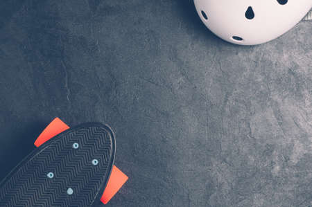 Skateboard and equipment on a dark background