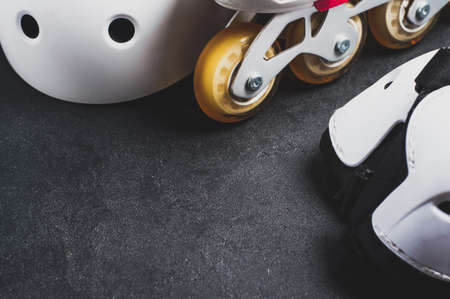 Roller skates and equipment on a dark backgroundの写真素材