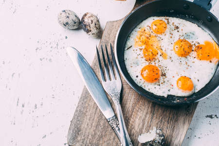 Scrambled eggs on wooden Board over shabby background. Space for text. Breakfast conceptの写真素材
